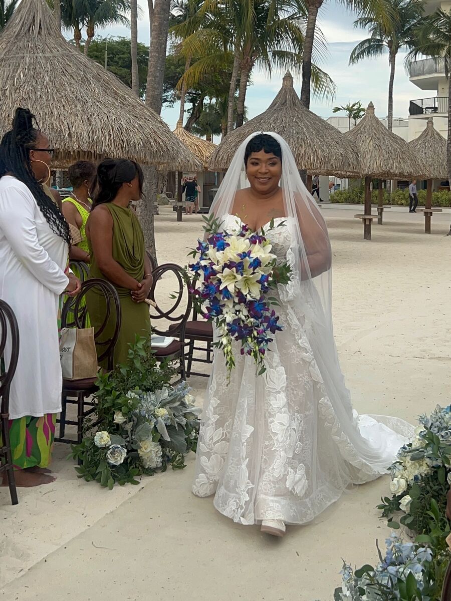 Yolanda Stith walking at a beach wedding